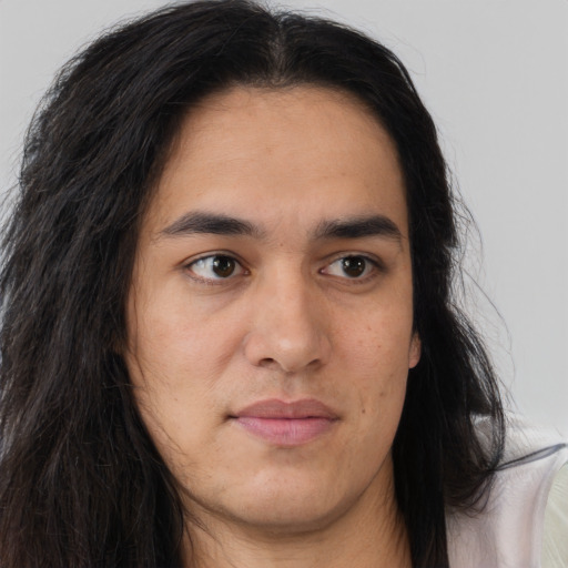Joyful white young-adult male with long  brown hair and brown eyes