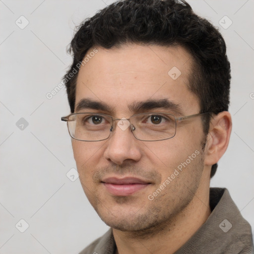 Joyful white adult male with short  black hair and brown eyes