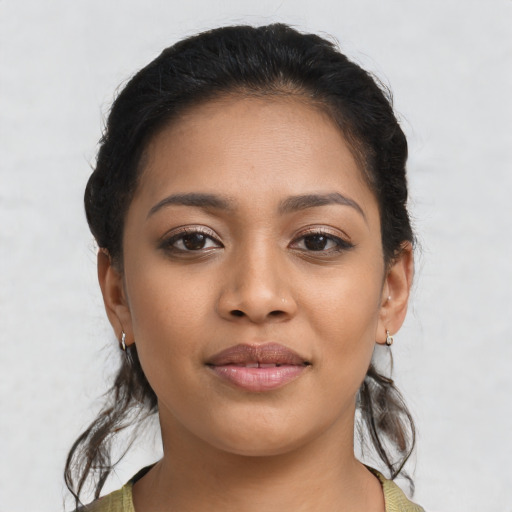 Joyful latino young-adult female with medium  brown hair and brown eyes
