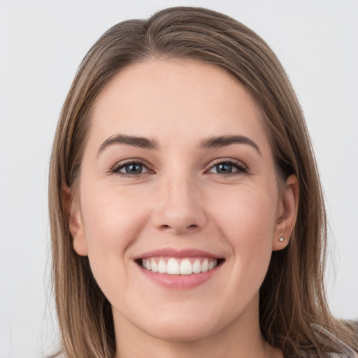 Joyful white young-adult female with long  brown hair and grey eyes