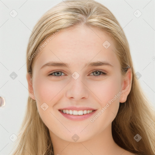 Joyful white young-adult female with long  brown hair and blue eyes