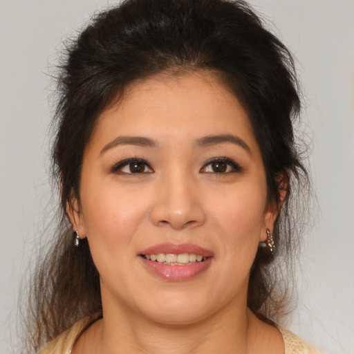 Joyful asian young-adult female with medium  brown hair and brown eyes
