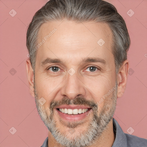 Joyful white adult male with short  brown hair and brown eyes