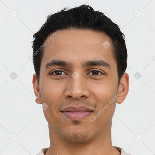 Joyful latino young-adult male with short  black hair and brown eyes