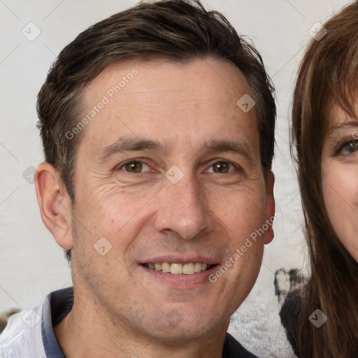 Joyful white adult male with short  brown hair and brown eyes