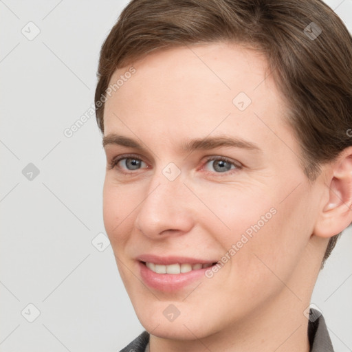 Joyful white young-adult female with short  brown hair and grey eyes