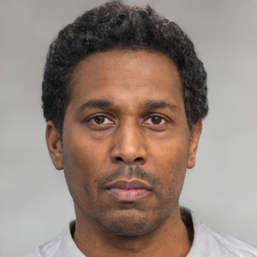 Neutral black adult male with short  black hair and brown eyes