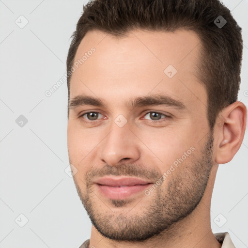 Joyful white young-adult male with short  brown hair and brown eyes