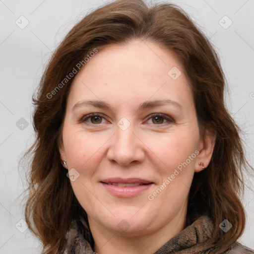 Joyful white adult female with long  brown hair and grey eyes