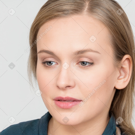 Joyful white young-adult female with long  brown hair and blue eyes