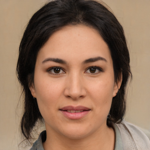 Joyful latino young-adult female with medium  black hair and brown eyes