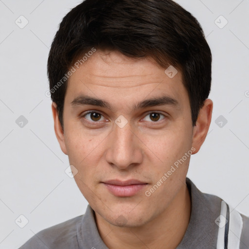 Joyful white young-adult male with short  brown hair and brown eyes