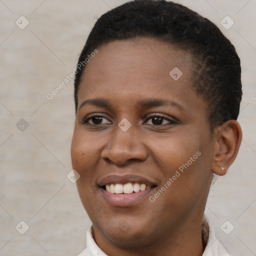 Joyful black young-adult female with short  black hair and brown eyes