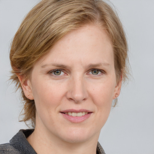 Joyful white adult female with medium  brown hair and blue eyes