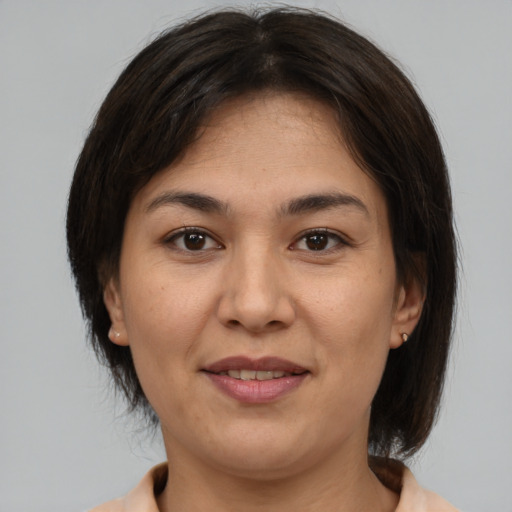 Joyful asian adult female with medium  brown hair and brown eyes
