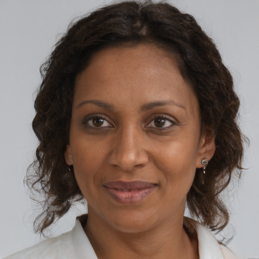 Joyful black adult female with medium  brown hair and brown eyes