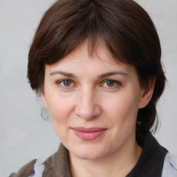 Joyful white adult female with medium  brown hair and brown eyes