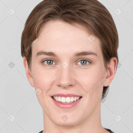 Joyful white young-adult female with short  brown hair and grey eyes