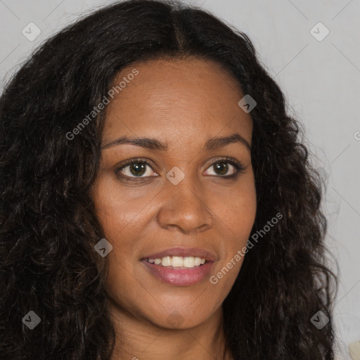 Joyful black young-adult female with long  brown hair and brown eyes