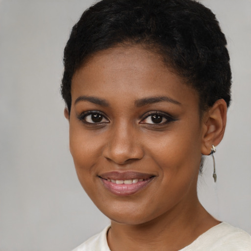 Joyful black young-adult female with short  brown hair and brown eyes