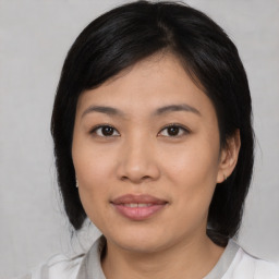 Joyful asian young-adult female with medium  black hair and brown eyes