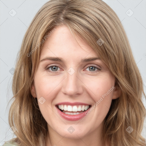 Joyful white young-adult female with medium  brown hair and green eyes