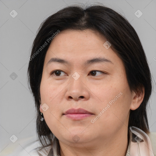 Joyful asian adult female with medium  brown hair and brown eyes