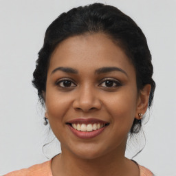 Joyful latino young-adult female with medium  brown hair and brown eyes