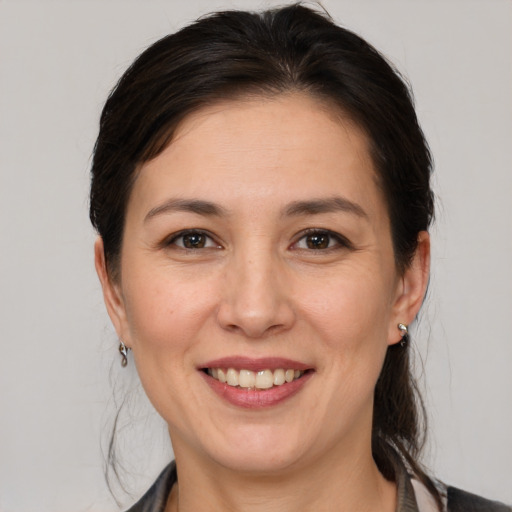 Joyful white young-adult female with medium  brown hair and brown eyes