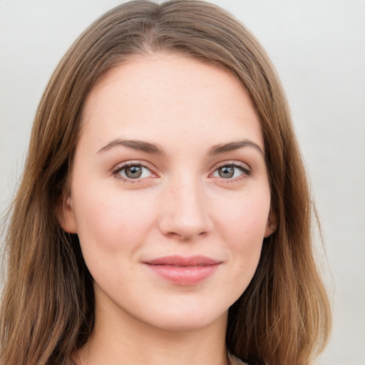 Joyful white young-adult female with long  brown hair and green eyes