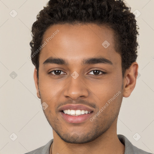 Joyful black young-adult male with short  brown hair and brown eyes