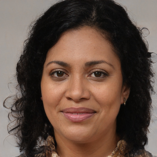 Joyful black adult female with medium  brown hair and brown eyes