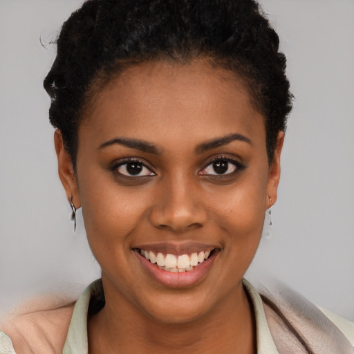 Joyful black young-adult female with short  brown hair and brown eyes