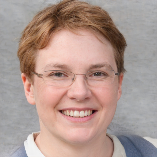 Joyful white young-adult female with short  brown hair and blue eyes