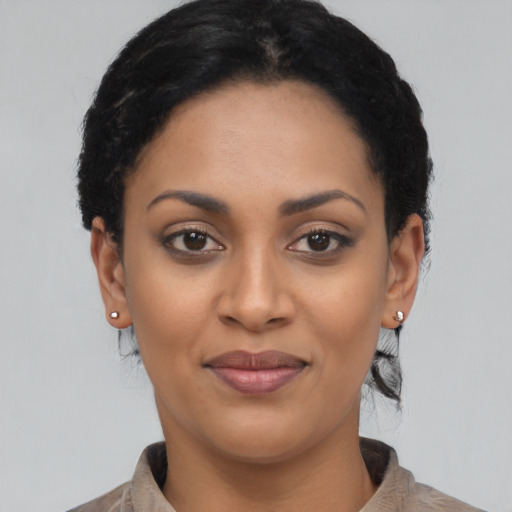 Joyful latino young-adult female with short  black hair and brown eyes