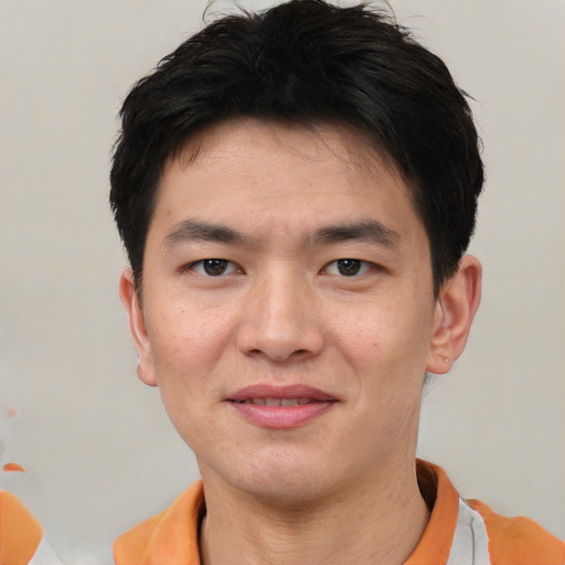 Joyful white young-adult male with short  black hair and brown eyes