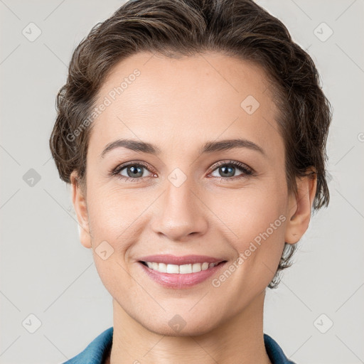 Joyful white young-adult female with short  brown hair and grey eyes