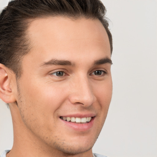 Joyful white young-adult male with short  brown hair and brown eyes