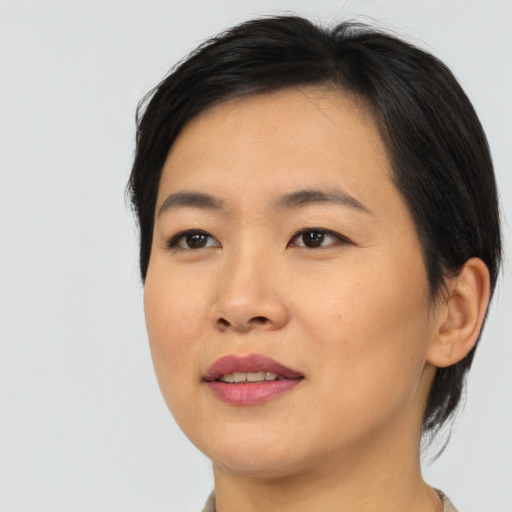 Joyful asian young-adult female with medium  black hair and brown eyes