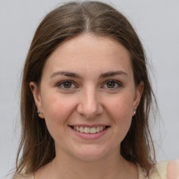 Joyful white young-adult female with medium  brown hair and grey eyes