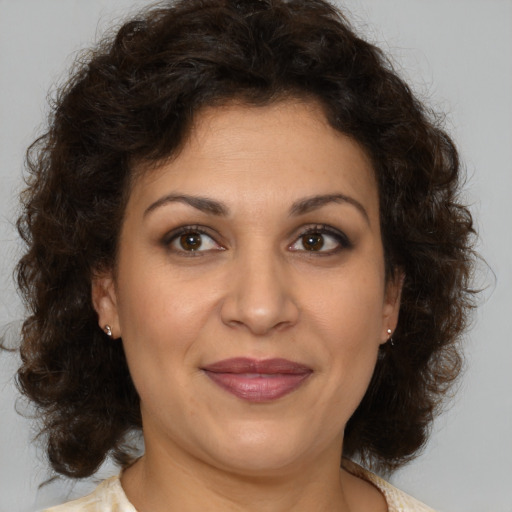 Joyful white adult female with medium  brown hair and brown eyes