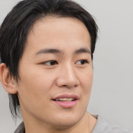 Joyful asian young-adult male with medium  brown hair and brown eyes