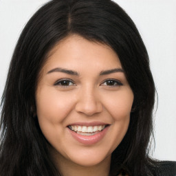 Joyful latino young-adult female with long  brown hair and brown eyes