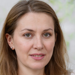 Joyful white young-adult female with long  brown hair and green eyes