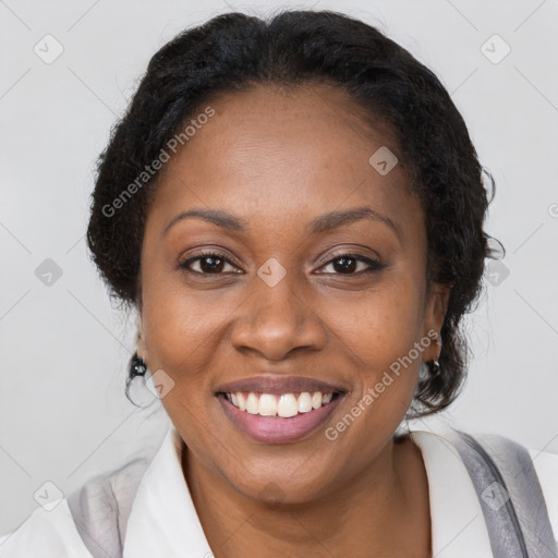 Joyful black adult female with medium  brown hair and brown eyes