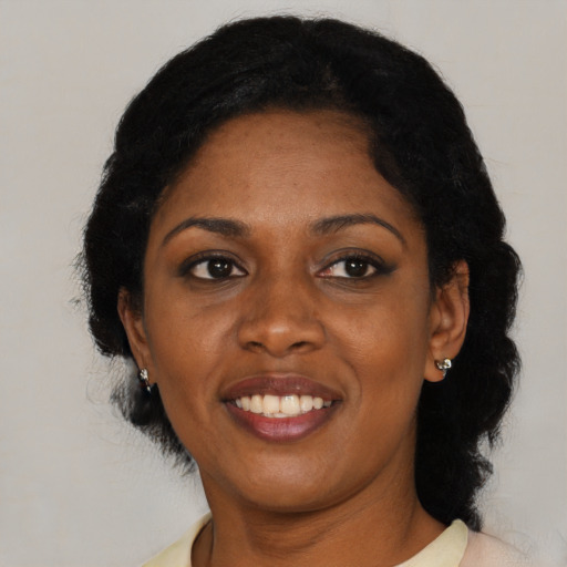 Joyful black adult female with medium  black hair and brown eyes