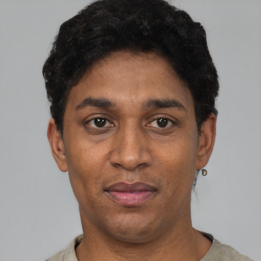 Joyful black young-adult male with short  black hair and brown eyes