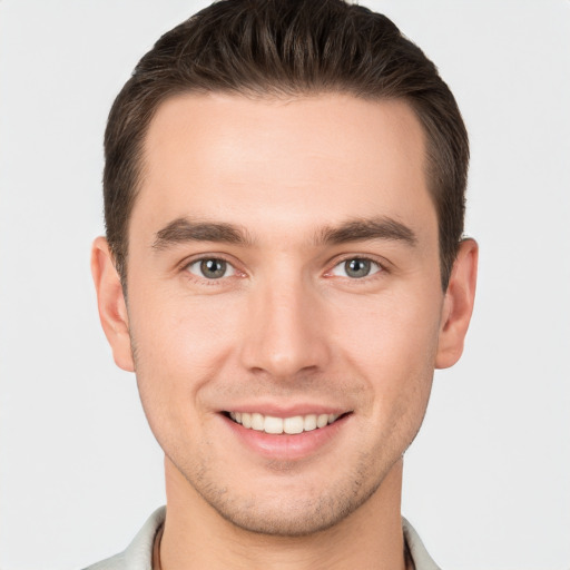 Joyful white young-adult male with short  brown hair and brown eyes