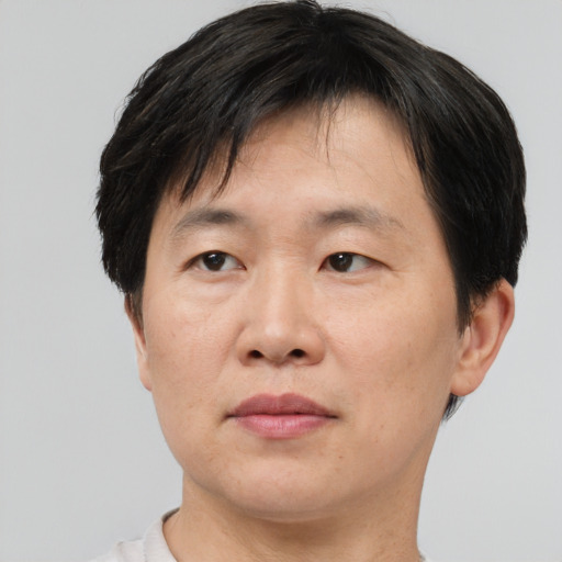 Neutral asian adult male with short  brown hair and brown eyes