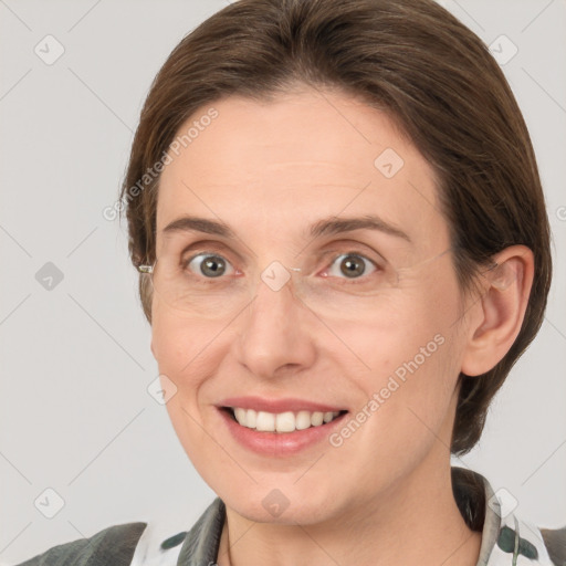 Joyful white adult female with medium  brown hair and grey eyes